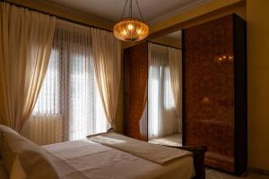 a bedroom with a bed and a large mirror at Casa Josephine in Taormina