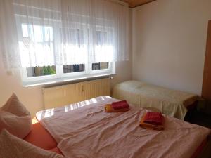 ヴェルニゲローデにあるFerienwohnung Mackのベッド2台と窓が備わる小さな客室です。