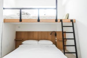 a bedroom with a bunk bed and a ladder at Ren Homestay in Hengchun