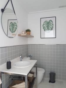 a bathroom with a sink and a mirror and a toilet at Ideal Ático-Duplex Deluxe, vistas al mar, Moraira. in Moraira +59 photos