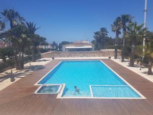a person is standing in a swimming pool at Apartamento Sa Perdiu 16 in Son Carrio
