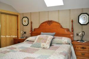 1 dormitorio con 1 cama grande y cabecero de madera en Casa Muro Ordesa, en Frajén