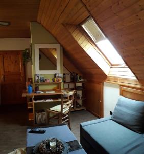 a room with a bed and a desk with a window at Stierstall-Suite Pension Wahlenau in Wahlenau