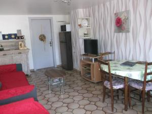 - un salon avec une table et un canapé dans l'établissement Gite les Rosiers, à Traubach-le-Bas