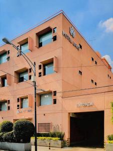 a large building with aadobeadobeadobeadobeadobeadobe at Hotel Lirio - Adult Only in Mexico City