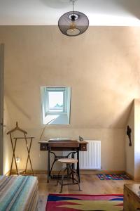 a room with a desk and a small window at Chambre d'Hôtes chez Artiste Verrier, La Perrière - Perche in La Perrière +13 photos