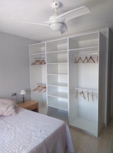 sypialnia z łóżkiem i wentylatorem sufitowym w obiekcie playas del cabo w mieście Almería
