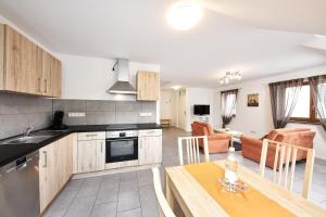 eine Küche und ein Wohnzimmer mit einem Tisch in der Unterkunft Ferienwohnung Weißburgunder in Lieser