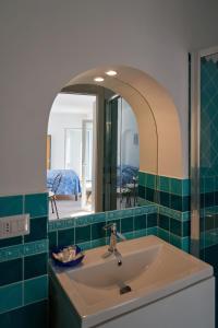 a bathroom with a sink and a mirror at Maiori Dream House 1 in Maiori