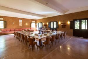 a large dining room with a long table and chairs at Ecolodge Quaryati Marrakech in Douar Tounsi