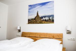 A bed or beds in a room at Landhotel Grashof