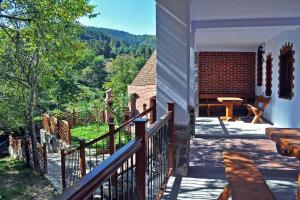 a balcony of a house with a table and a view at Casa Crina in Sălişte