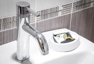 a bathroom sink with a faucet and a bowl with a brush at Marina's Elegance in Kriopigi +105 photos
