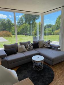 a living room with a couch and a large window at MONzeit in Monschau