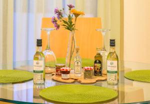 un tavolo con bottiglie di vino e piatti di Marina's Elegance a Kriopigi