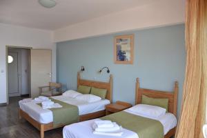 A bed or beds in a room at Thalassa House Apartments