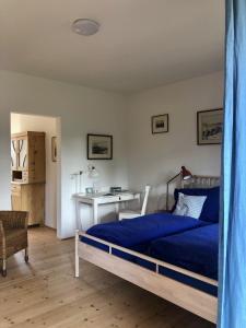 a bedroom with a bed and a desk at Sonnhof Ressl in Klosterneuburg