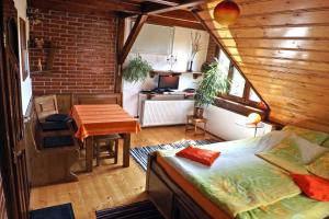 a room with a bed and a table in a room at Casa Crina in Sălişte