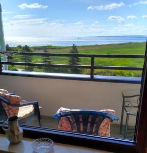 a view of the ocean from the balcony of a house at Ferienwohnung mit Meerblick in Damp