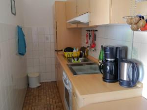 a small kitchen with a sink and a microwave at Ferienwohnung mit Meerblick in Damp