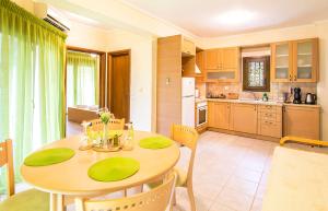 a kitchen and dining room with a table and chairs at Marina's Elegance in Kriopigi