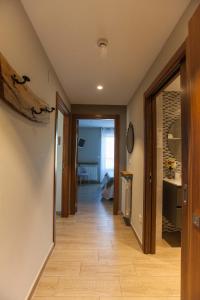 a hallway leading to a living room with a wood floor at Endaneta Berri in Zumaia +87 photos