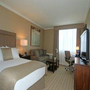 a hotel room with a bed and a television at Ethan Allen Hotel in Danbury