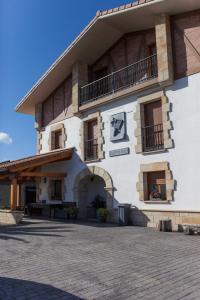 a large white building with a balcony and a patio at Endaneta Berri in Zumaia