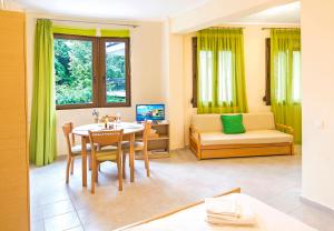 a living room with a table and a couch at Marina's Elegance in Kriopigi