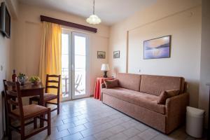 a living room with a couch and a table at Eriphilly Studios & Apartments in Mythimna