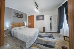 a bedroom with a bed and a rug in it at Rustico alla Quercetta in Verona