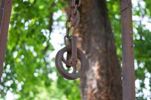 an old rusty chain hanging from a tree at Rustico alla Quercetta in Verona