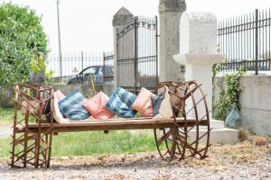 a bench with pillows on it in a cemetery at Rustico alla Quercetta in Verona