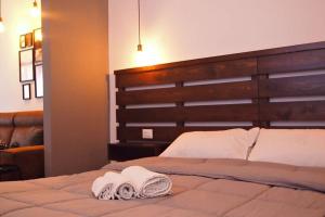 a bedroom with a bed with two towels on it at La Perla in Naro