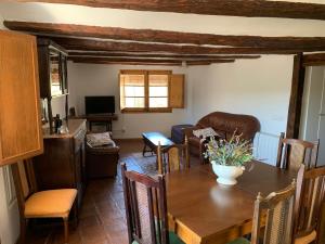 a living room with a table and a couch at Casa Marqueso in Figuerola de Orcau +11 photos