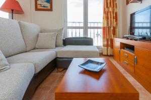 a living room with a couch and a coffee table at Holiday Apartment Casa Vista Mar Oliastur El Cotillo in Cotillo