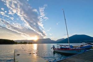 a boat is docked at a dock on a lake at Casa Marqueso in Figuerola de Orcau