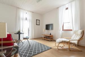 a living room with a couch and a tv at OPN Apartments Bled in Bled