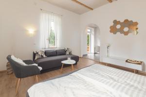 a living room with a bed and a couch at OPN Apartments Bled in Bled