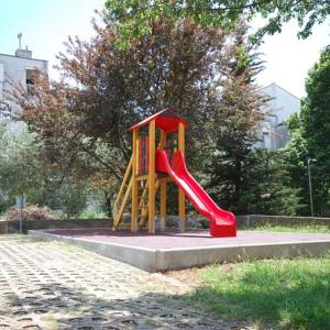 a playground with a slide in a park at Apartman Vesna 4 persons in Njivice