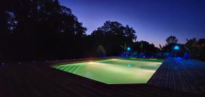 a swimming pool lit up at night at La Folie Hubert in Meung-sur-Loire