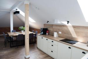 a kitchen with a table and a dining room at Apartament, pokoje ,domek Ach To Tu in Mikołajki