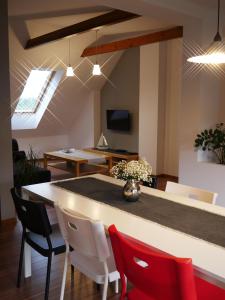 a kitchen and dining room with a table and chairs at Przy Przystani in Stegna