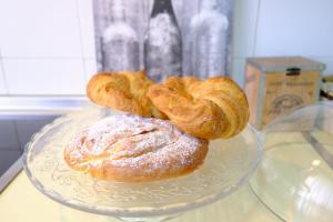three pastries on a glass plate on a table at Vallespin Suite in Avila +13 photos