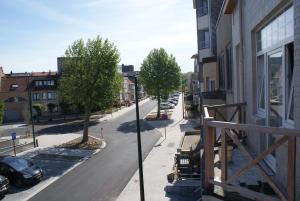 a view of a street from a balcony of a building at Lou Le Lavandou in De Panne