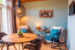 a dining room with a table and chairs at Bed en Bike Texel in Den Burg