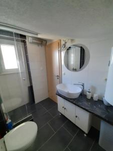 a bathroom with a sink and a toilet and a mirror at Ana Marija in Solin +52 photos