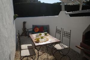 una mesa y sillas en un patio en Le Mas des Trémaïé en Saintes-Maries-de-la-Mer