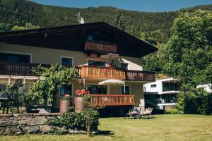 a large house with a balcony with people on it at Haus am Stein in Oetz