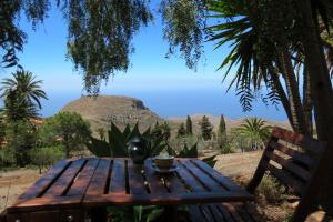 a wooden table with a vase sitting on top of it at Vistas del Sur in Alajeró